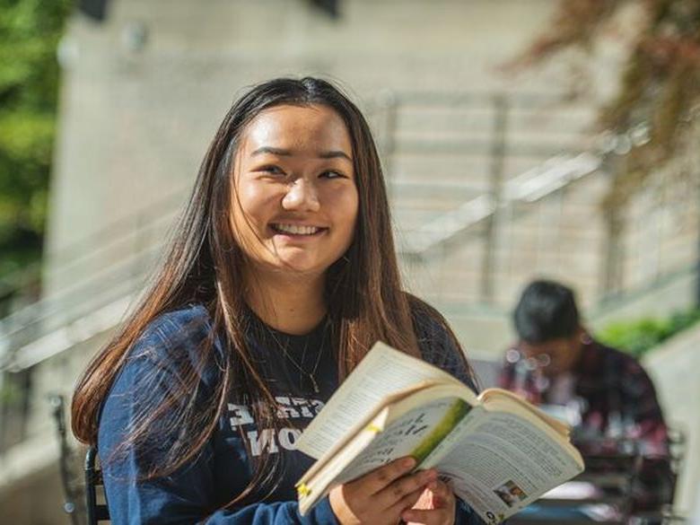 A student reads a book at Penn State Abington (near Philadelphia)